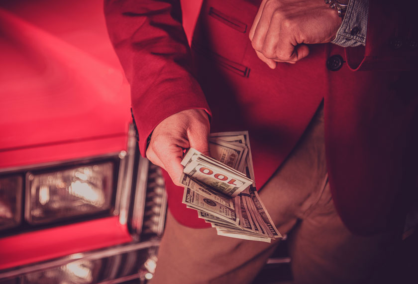 Close up of a person counting cash.